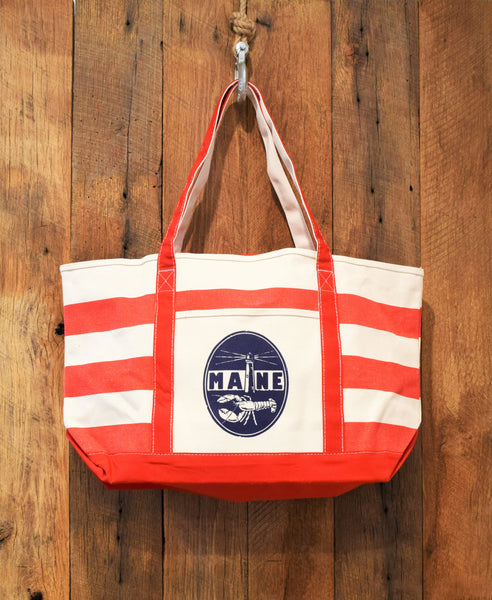 red beach bag with lighthouse print